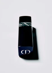 Close-up product shot of a black lipstick tube with silver CD logo and metallic band against a white background.