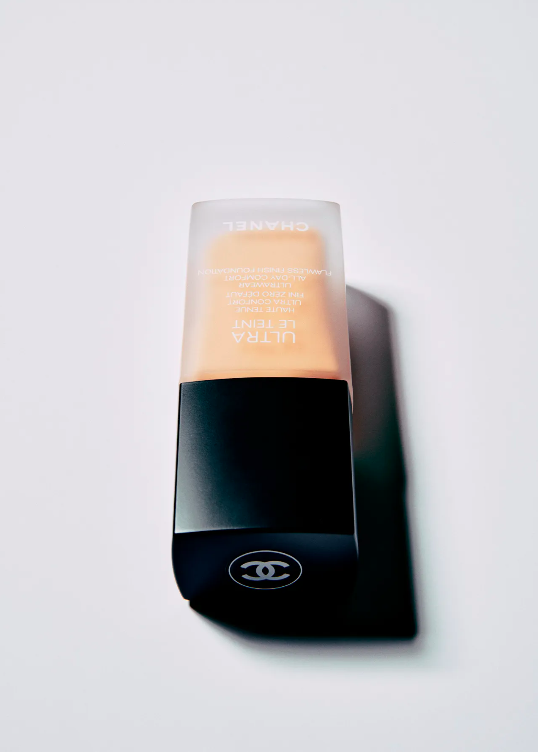 Studio shot of Chanel Ultra Le Teint foundation bottle against a clean white backdrop, highlighting its sleek design and cosmetic appeal.