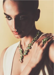 Close-up fashion portrait of Anjali Torvi wearing a green crystal necklace and matching ring for Grazia Australia