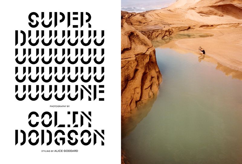 Landscape shot of a tranquil lake surrounded by eroded rock formations. A lone person bathes in the still water under natural lighting.