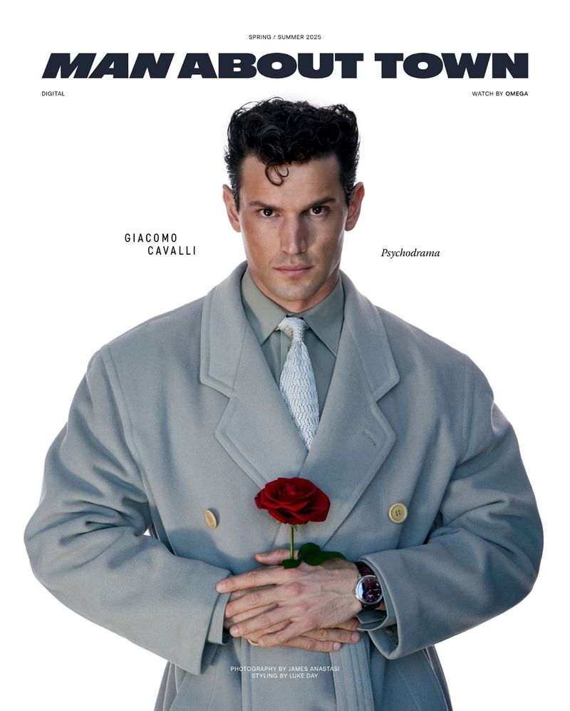 Man in grey coat holds red rose in a studio setting, fashion magazine cover. Spring/Summer 2021 fashion editorial.