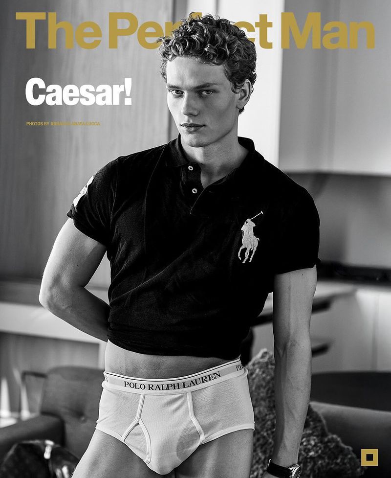 Magazine cover features a young adult male model in a black Polo shirt and white Polo Ralph Lauren briefs, posing indoors.