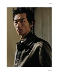 Close-up portrait of male model Bai wearing a dark leather jacket in a fashion editorial for Esquire China photographed by Matthieu Delbreuve.