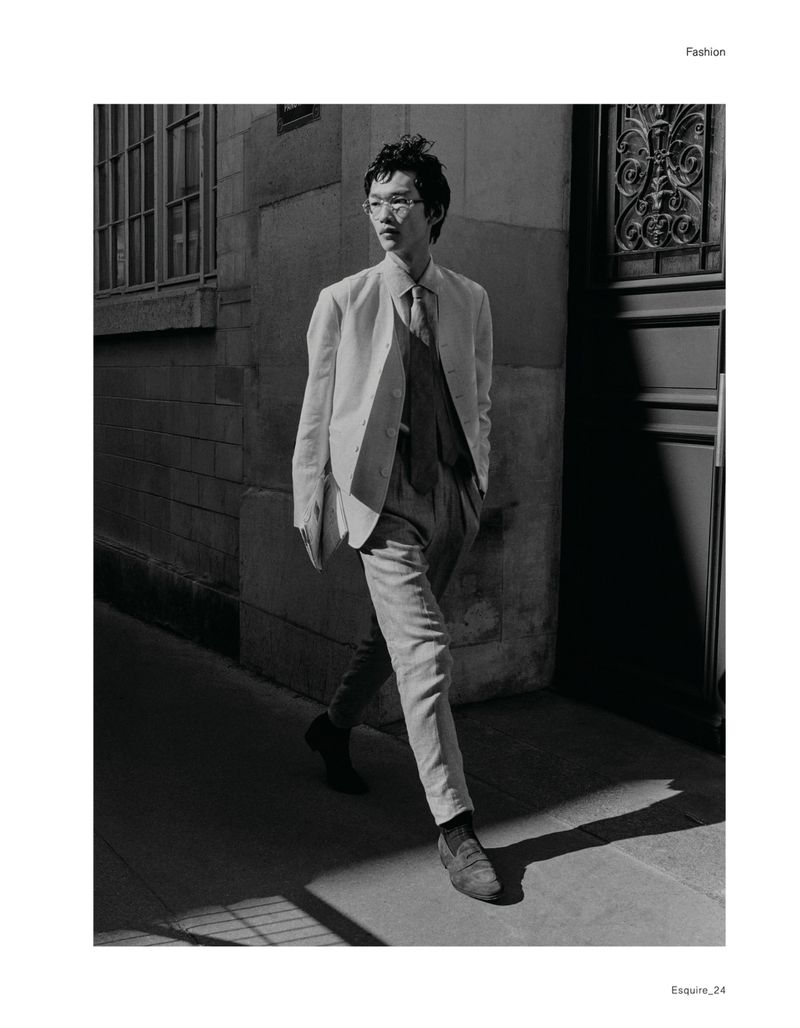 Model Bai walking down a street in a tailored suit and tie for Esquire China editorial RUSH ! TIME OUT