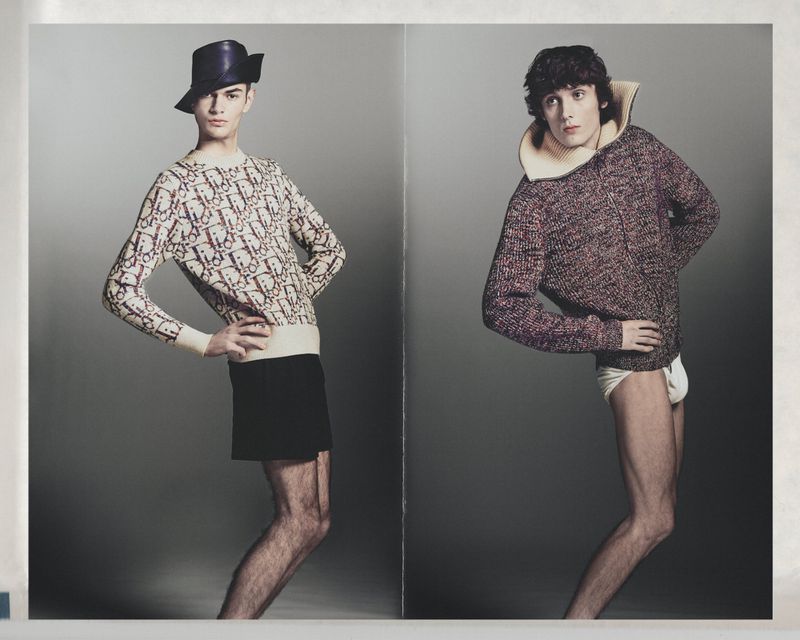 Two male models posing side by side against a neutral grey studio background for Numero Netherlands