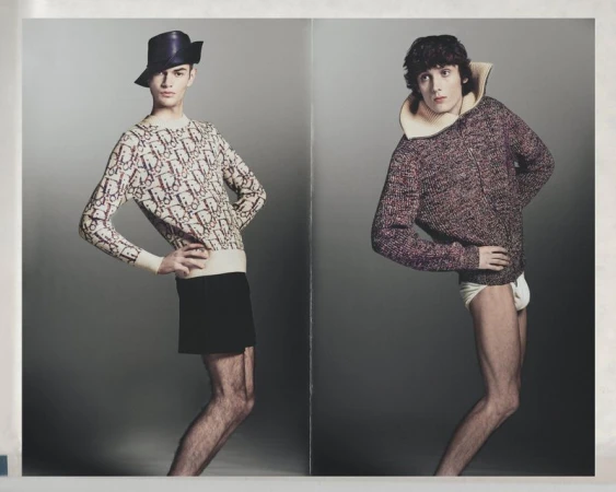 Two male models posing side by side against a neutral grey studio background for Numero Netherlands