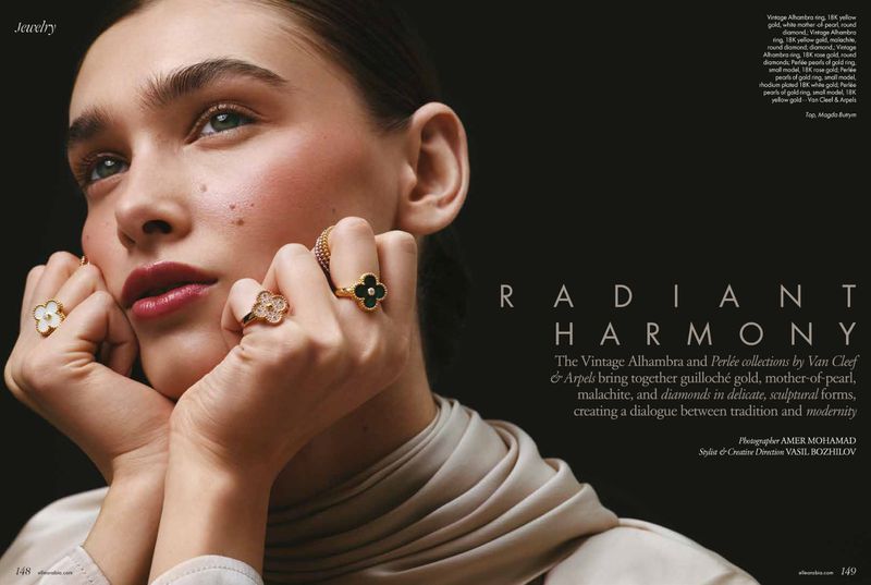 Close-up studio shot of a young adult woman with fair skin wearing clover-shaped gold rings with diamonds and black and white gemstones.