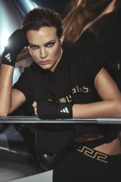 Model Josephine Skriver wearing black athletic apparel with hand wraps leaning on a railing in Elle Bulgaria editorial
