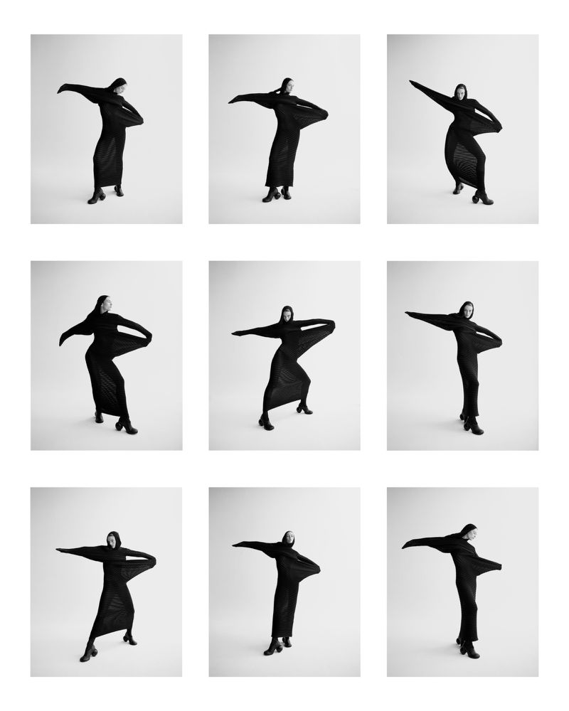 Nine monochrome frames showcase a woman in a black dress with outstretched arms against a clean white backdrop, creating a minimalist fashion photo.