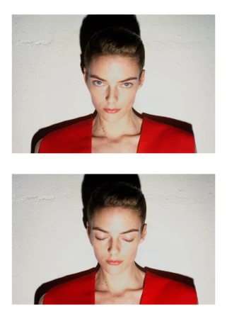 Model Beauïse Genç in a red top with a dark shadow cast on the textured wall behind, for Exhibition Magazine Ti Amo.