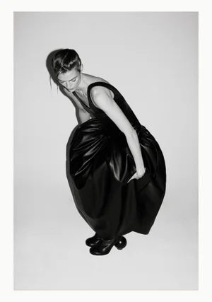 Model Beauïse Genç in a sculptural black dress against a white studio background for Exhibition Magazine Ti Amo