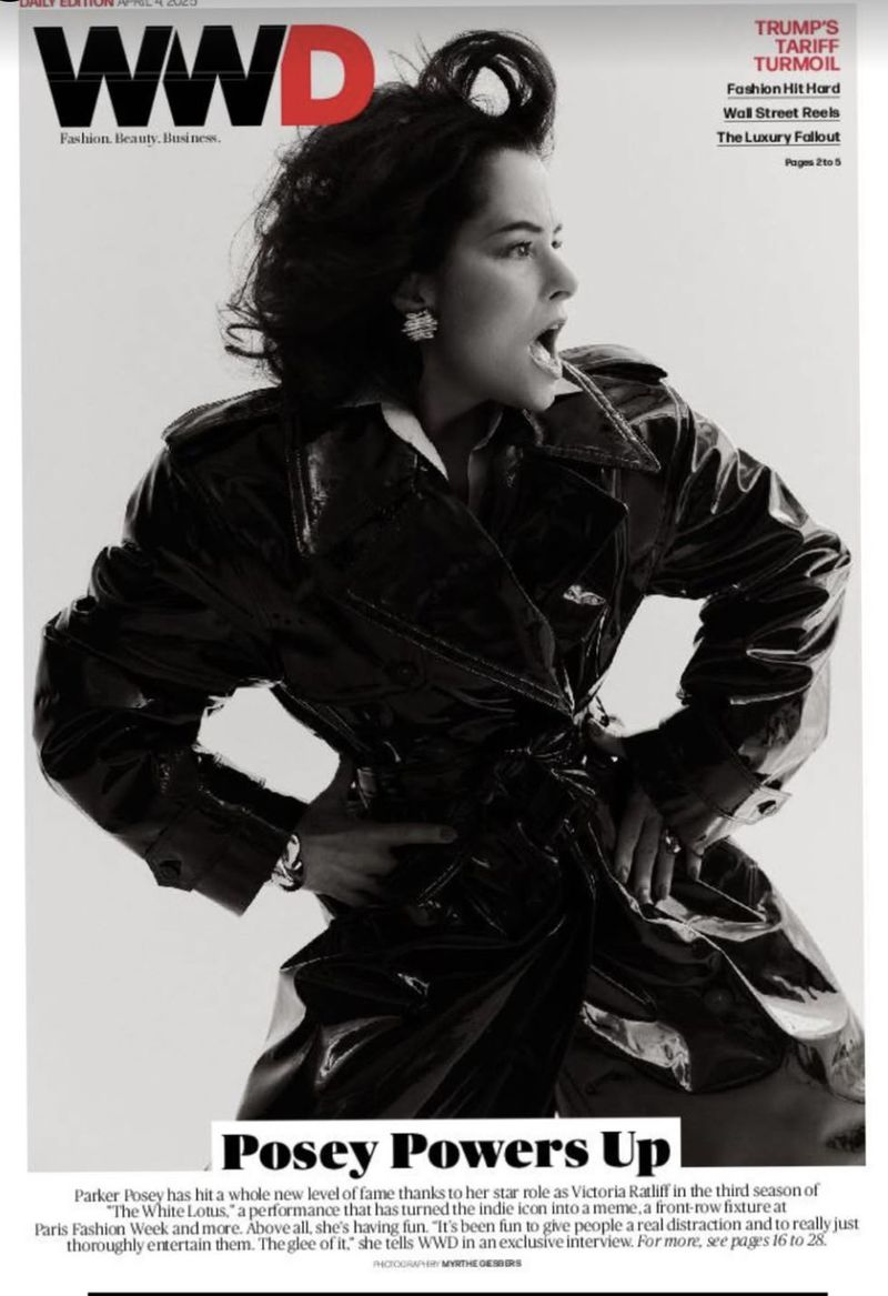 Magazine cover featuring a woman in a dark, shiny coat against a light background with WWD masthead. Text reads, 'Posey Powers Up'.