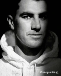 Black and white portrait of Pat Cummins wearing a white hoodie, photographed by Georges Antoni for Esquire Australia.