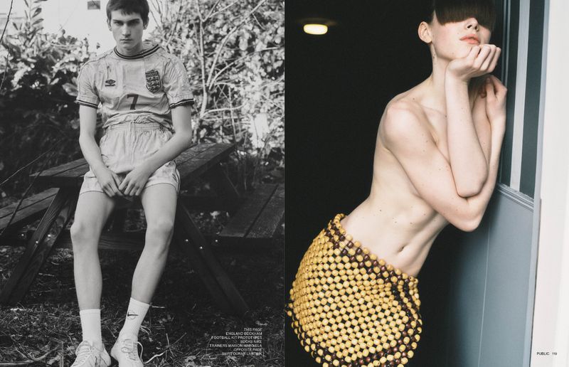 Monochrome image with a male model in a soccer uniform seated on a picnic table and a female model with an beaded skirt.
