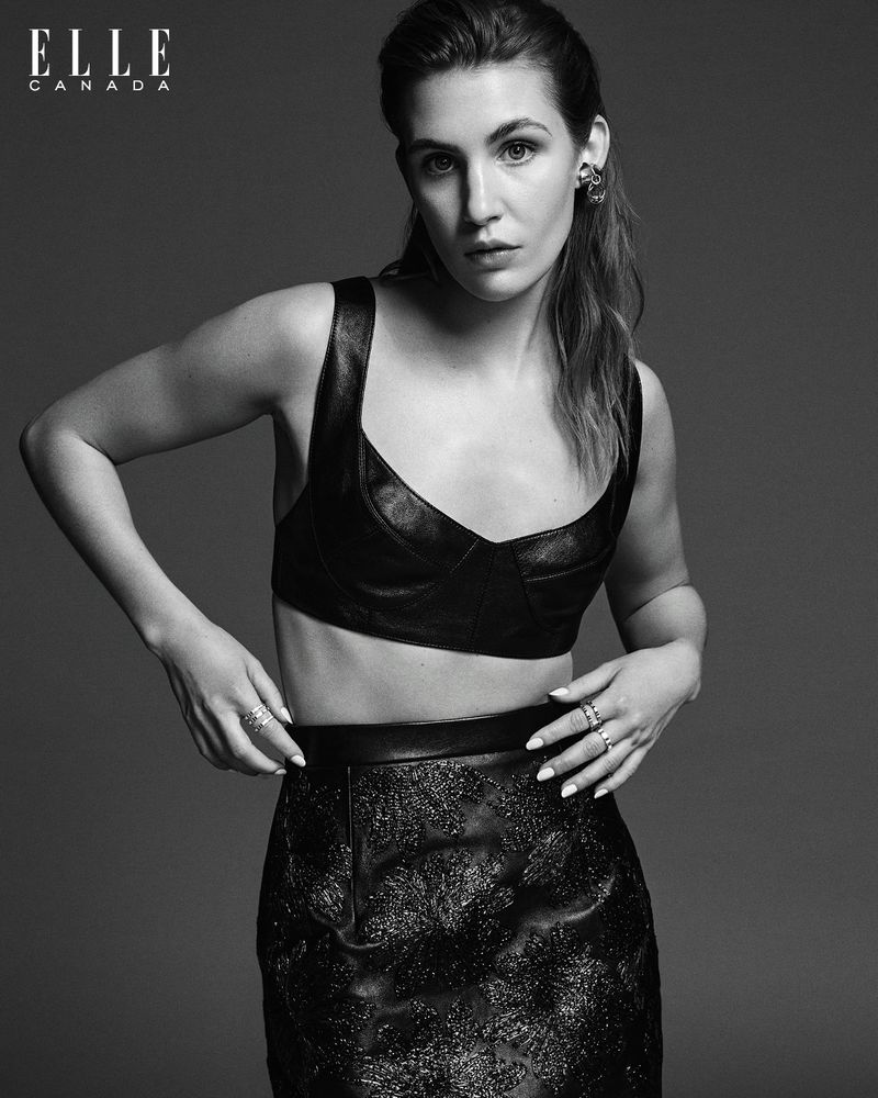 Black and white portrait of an adult woman in a leather crop top and skirt, with Elle Canada logo visible in the upper left corner.