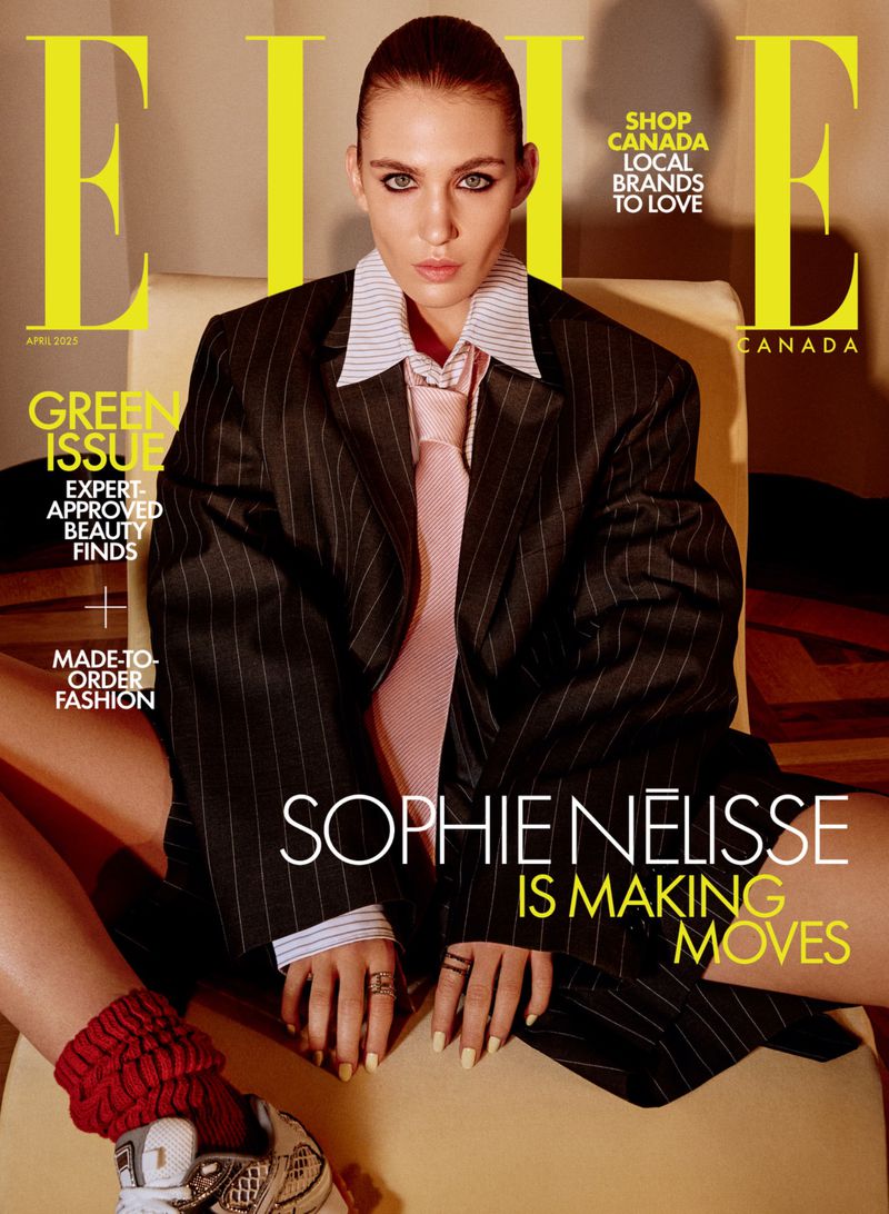 Magazine cover featuring Sophie Nélisse in an oversized pinstripe suit, white collared shirt and pink tie, with bright yellow 'ELLE' logo.