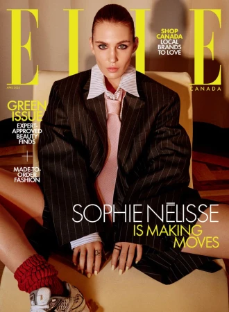 Magazine cover featuring Sophie Nélisse in an oversized pinstripe suit, white collared shirt and pink tie, with bright yellow 'ELLE' logo.
