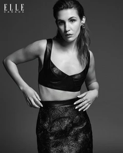 Black and white portrait of actress Sophie Nelisse wearing a dark leather crop top and textured skirt for Elle Canada.