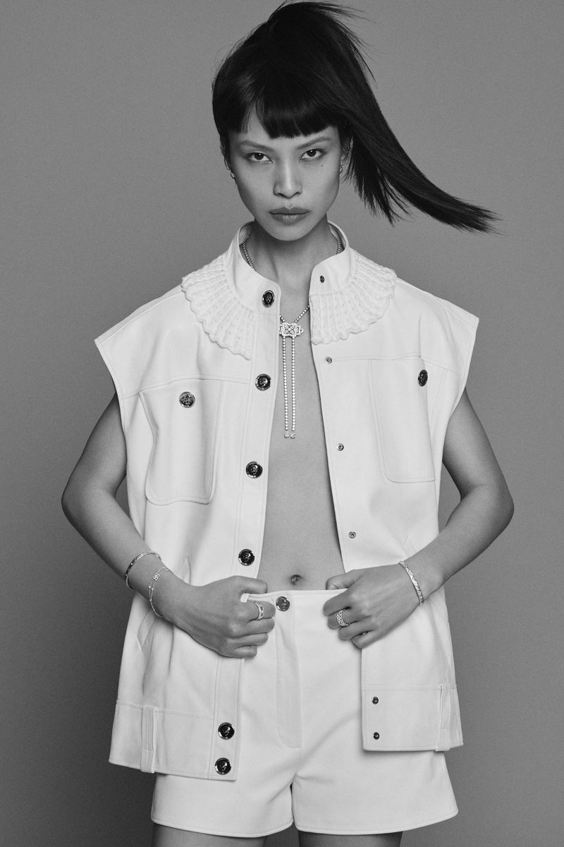 Model Diane Chiu in white vest and shorts with dark high ponytail for Pop Magazine editorial by Paul Wetherell