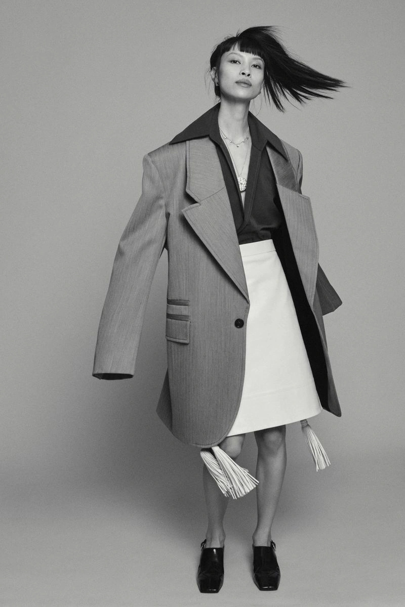Model Diane Chiu in an oversized grey blazer and white skirt for Pop Magazine photographed by Paul Wetherell