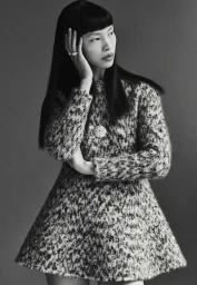 Model Diane Chiu in a textured patterned dress with long dark hair posing against a neutral grey studio background for Pop Magazine.