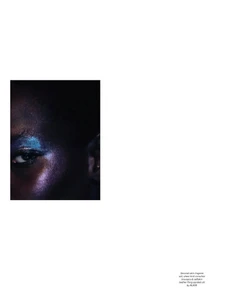 Macro beauty shot featuring a black woman with iridescent blue eyeshadow and shimmering dark skin tones.
