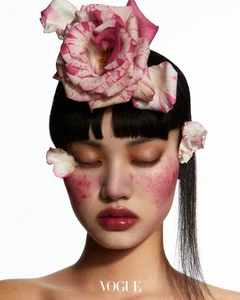 Model Wenqing Liu with pink rose petals on hair and cheeks for Vogue Thailand Flora-Vaganza editorial