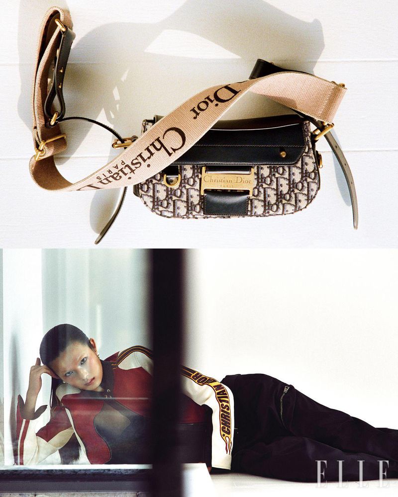 Fashion shot featuring an Asian woman reclining indoors with a Christian Dior handbag and strap laid on a white surface.