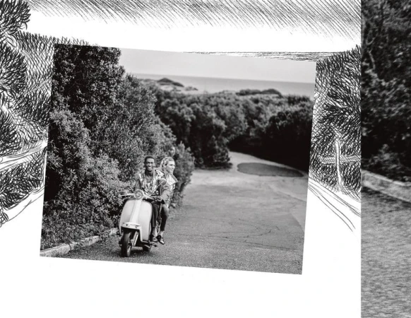 Black and white photo of a smiling man and woman riding a scooter down a road lined with trees, creating a travel or lifestyle image.