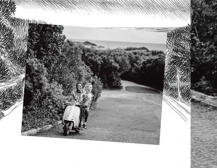 Black and white editorial image of two models riding a motor scooter down an outdoor path flanked by trees for Hermes.