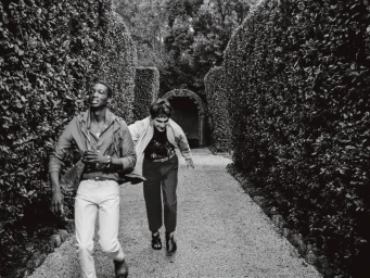 Two male models running along a gravel path flanked by tall clipped hedges for Le Monde d'Hermes editorial