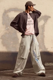 Model Hoyong Kim wearing a plaid shirt, pink t-shirt, and distressed light jeans for H&M K-Street campaign