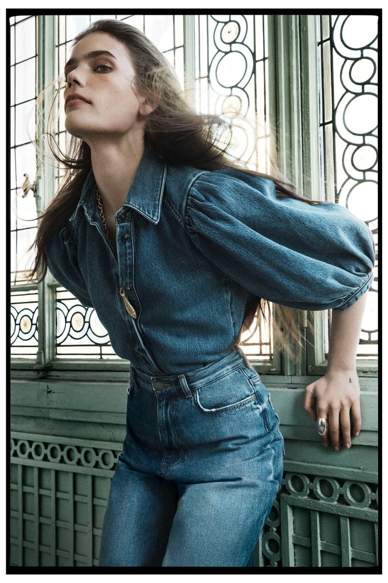 Model in denim shirt and jeans leaning against a green patterned window for Zara New Romantics campaign