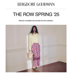 Model Ana Elisa Brito wearing a pale yellow sweater and patterned skirt holding a straw bag in front of a white wall