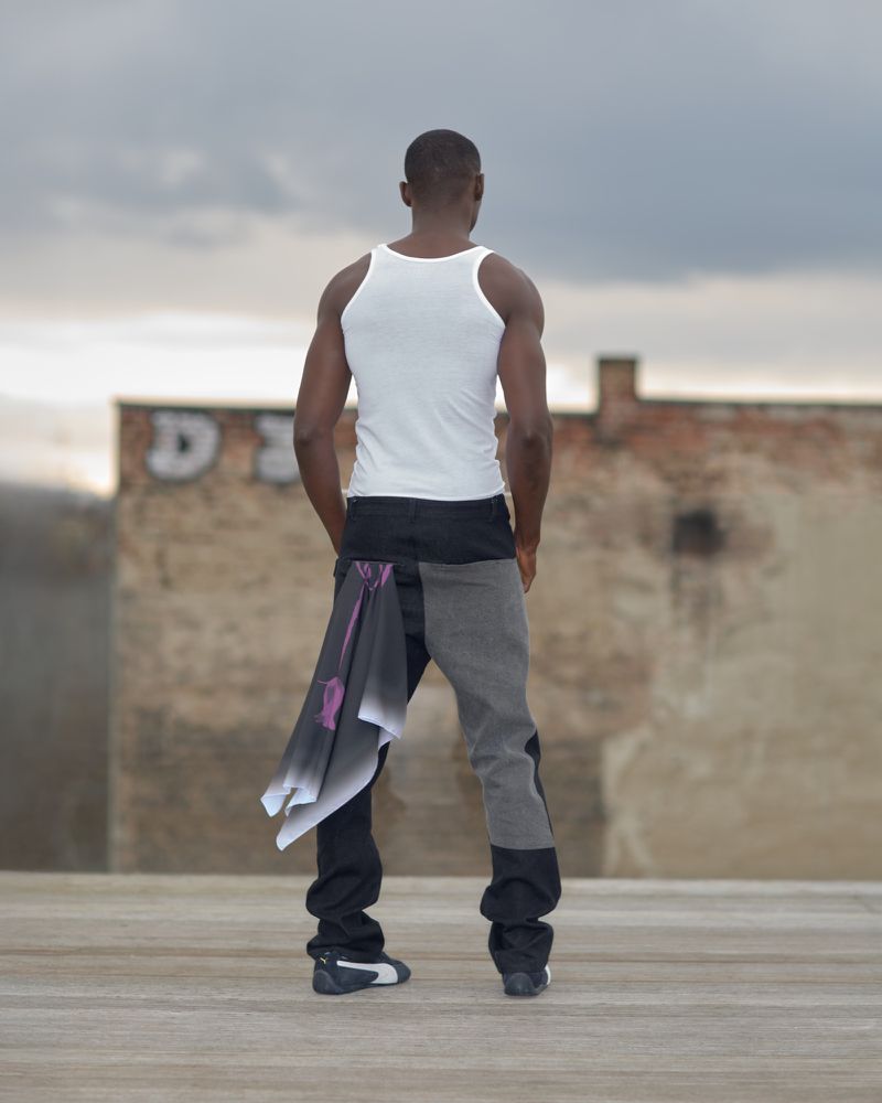Black man in a white tank top and grey jeans with a scarf, stands on a rooftop, looking at a building against an overcast sky backdrop.