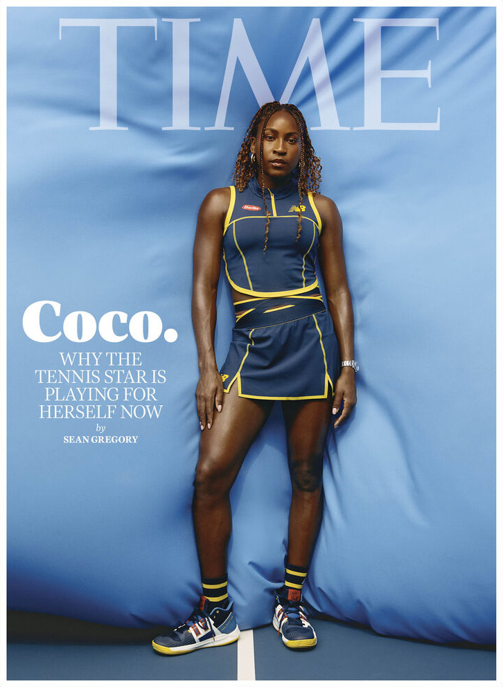 Full-length portrait of Coco Gauff on TIME cover. Gauff wears a navy blue and gold tennis outfit against a light blue studio backdrop.