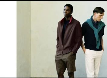 Two male models posing for Paul Stuart 2025 Spring collection against a neutral studio backdrop.
