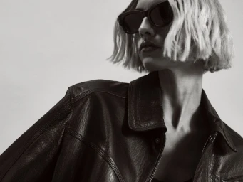 Model in dark sunglasses and a black leather jacket against a light background for Nour Hammour Spring Summer 25.