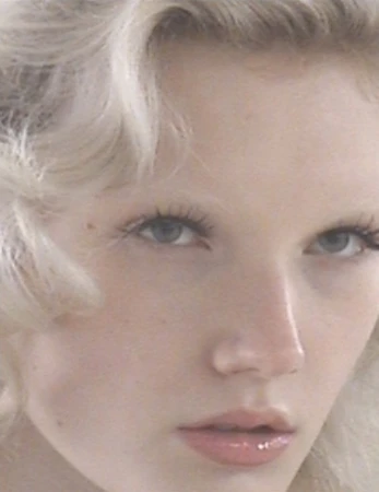 Close-up portrait of a model with blonde hair and light blue eyes for ALL-IN fall winter 2025 ready-to-wear collection.
