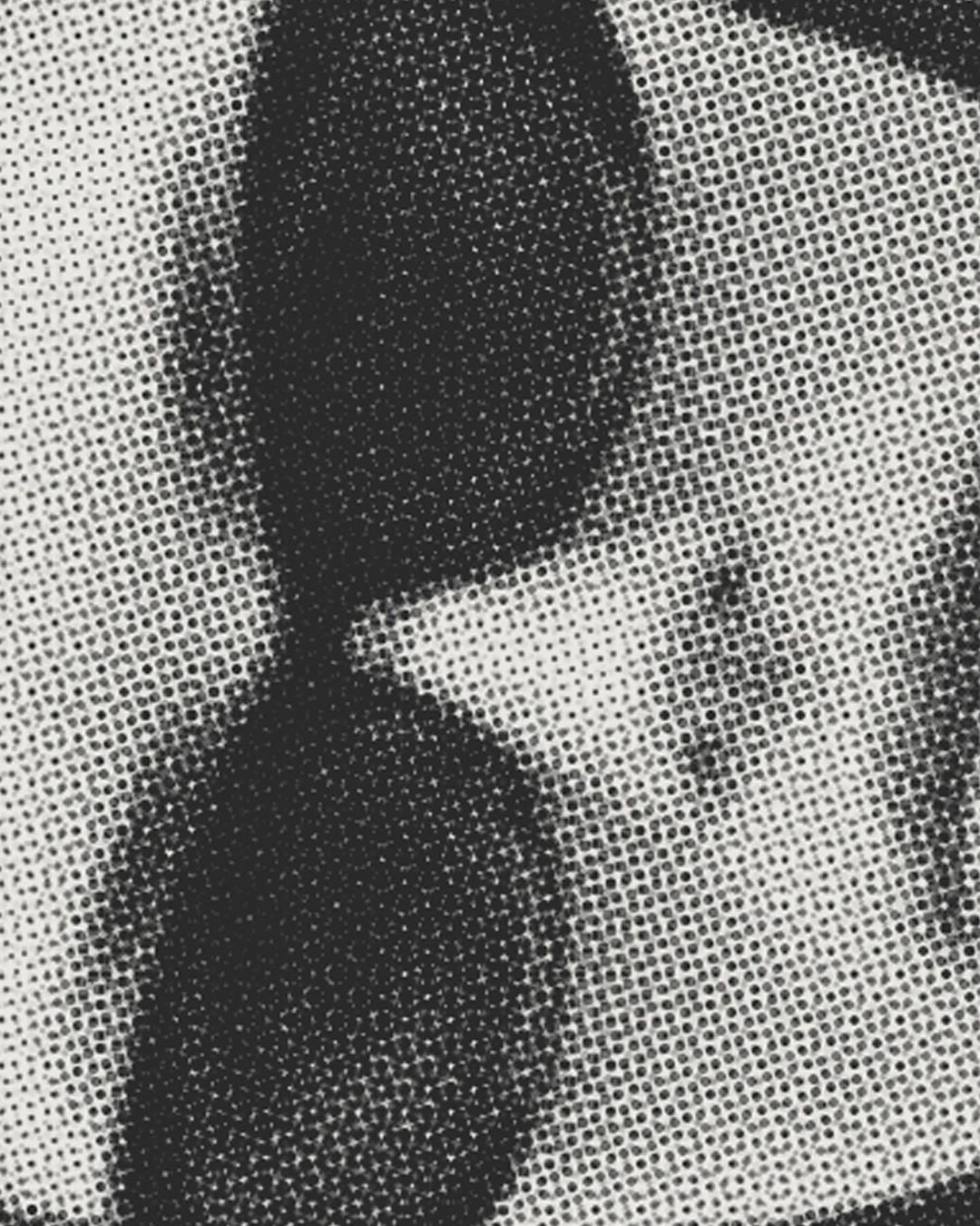 Monochromatic image featuring a close-up of a surface with a halftone pattern in varying shades of gray, creating an abstract visual.