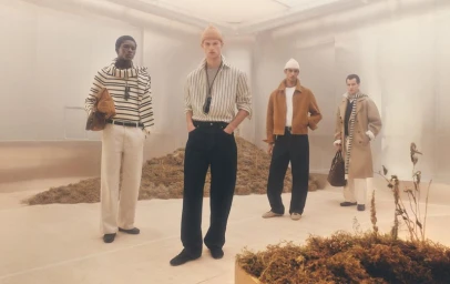 Four male models in stylish menswear outfits posing in a minimalist studio set with earthy mounds for Zara Edition Collection.