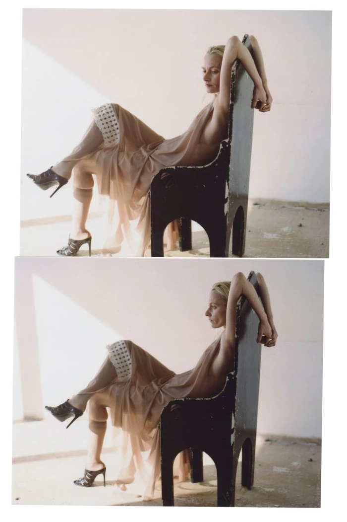 Model in a draped nude dress seated on a tall black chair against a pale wall for Diotima Fall Winter 25