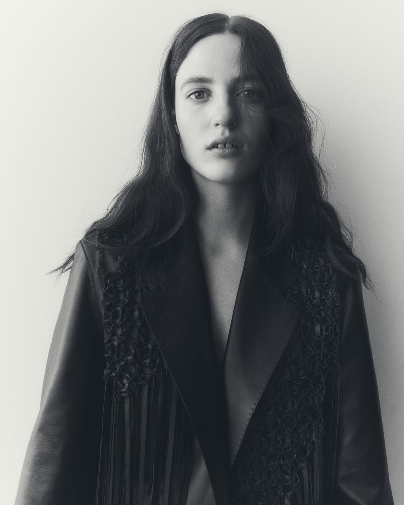 Portrait of female model Julia Banas wearing a dark jacket against a plain white background for Lafayette 148
