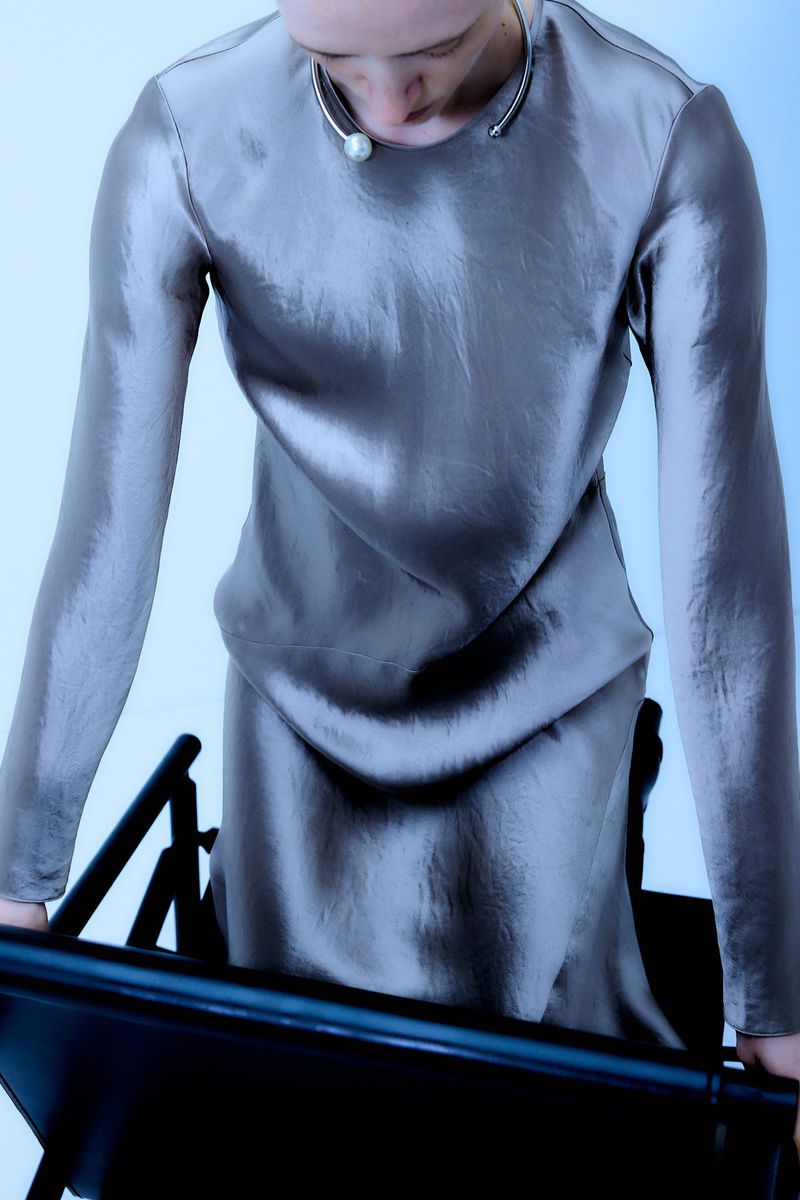 Model Helena Severin wearing a metallic grey dress and pearl collar for Max Mara campaign fw2024/25