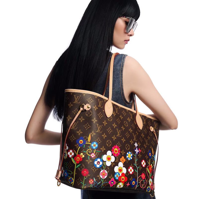 Woman with long dark hair wearing sunglasses and a dark sleeveless top carrying a brown Louis Vuitton bag with colorful flower designs.