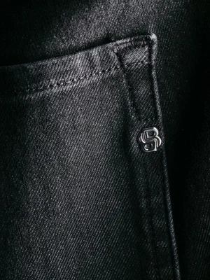 Close-up of dark denim jeans pocket with topstitching and metal logo hardware for the Boss X David Beckham collection