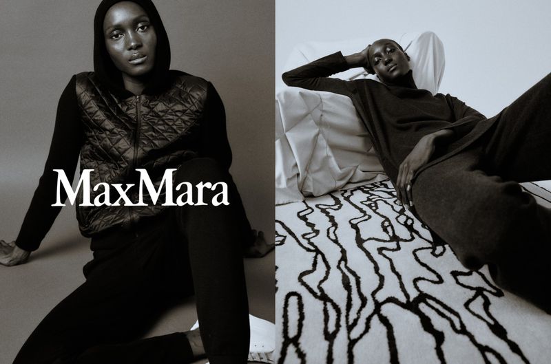 Fashion shoot featuring two black female models wearing dark clothing. One model is wearing a quilted vest with Max Mara logo.