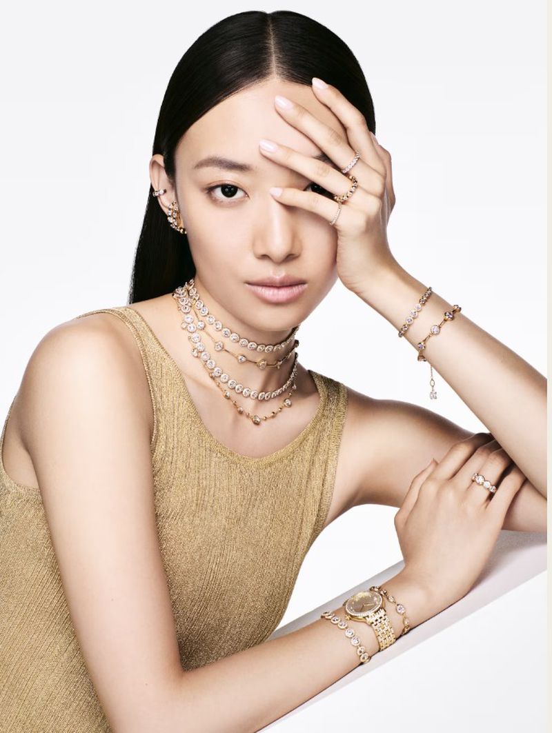 Model wearing crystal necklaces and gold watch against a clean white background for Swarovski Spring/Summer 2025 Lookbook