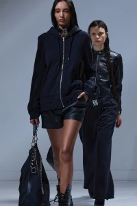 Two female models walking the runway wearing dark apparel for R13 Fall 2025 Ready-To-Wear collection