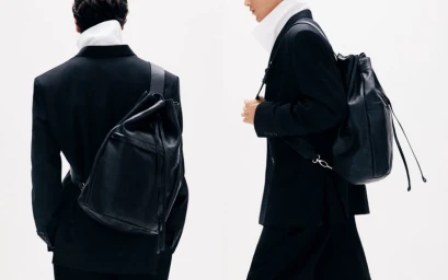 Two men wearing black blazers and leather backpacks against a plain white background for COS AW24.